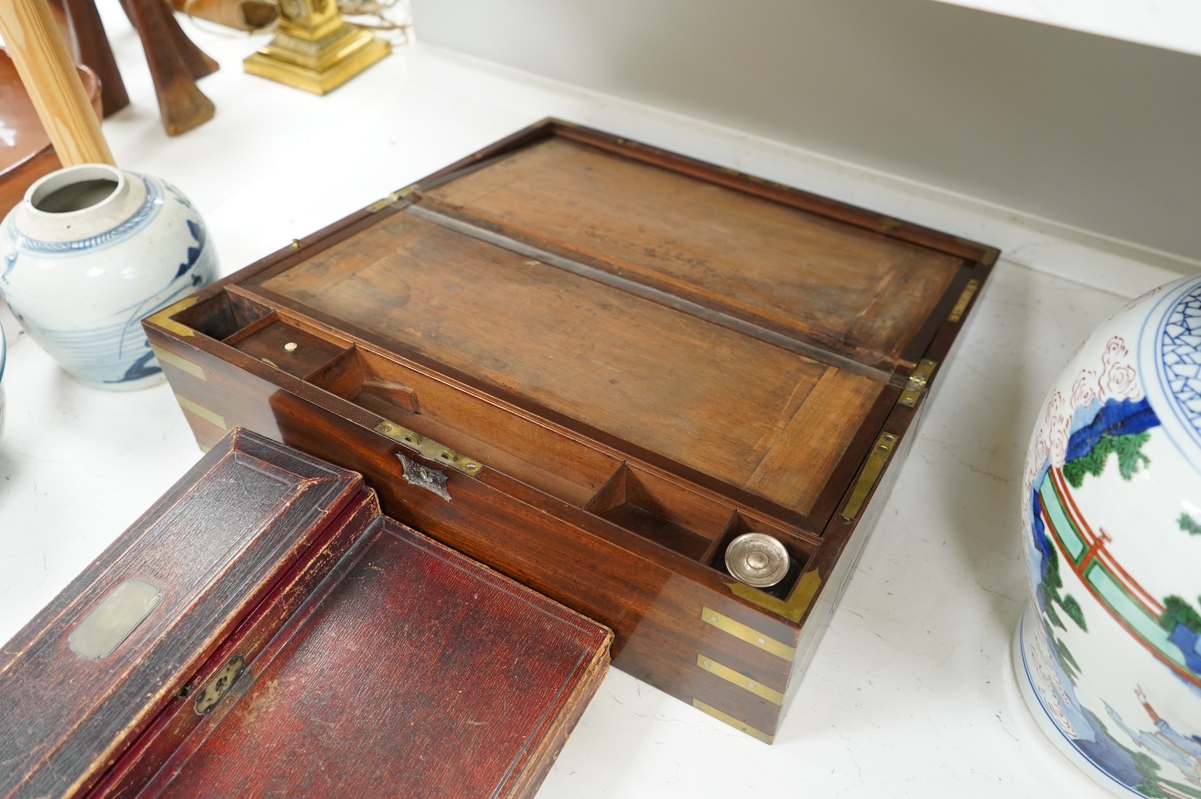 A Victorian brass bound mahogany writing slope and a Regency leather covered writing slope, 50cm wide